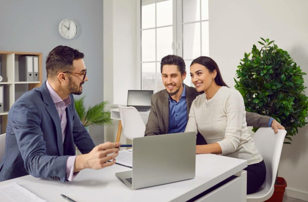 A professional advisor meets with two entrepreneurs to discuss nursing home ownership and investment strategies.